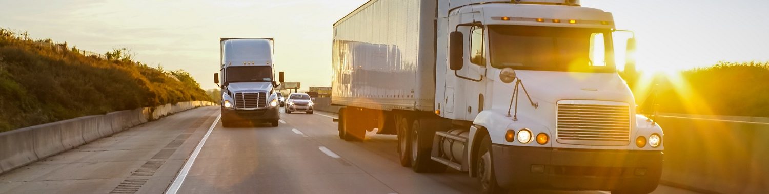 Gemini Transportation Semi truck on highway at sunset